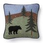 This square pillow features a bear among a mountain scene and trees.