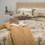 Lifestyle image of Donna Sharp Cowboy Cotton Quilt Set featured with the Camel Chunky Knit Throw.