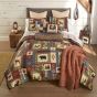 This quilt features a series of wildlife and cabin motifs.