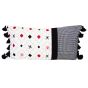 The back of this pillow has a fun design in red, black, and grey with tassels on each end.
