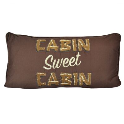 The front of this pillow says Cabin Sweet Cabin.