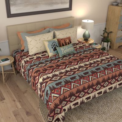This quilt set has a striped Southwest pattern, bears and pine tree silhouettes.