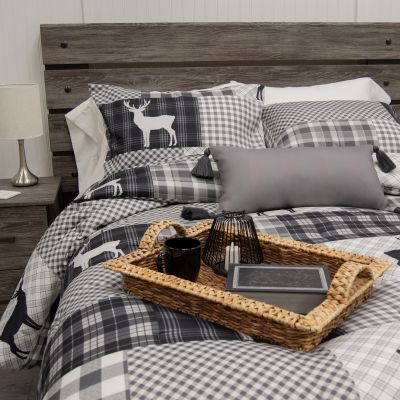 Ridge Point 3-Piece Comforter Set includes a black and white plaid comforter with deer motif, reversible to a grey and white pattern. Set includes 2 coordinating pillowcases. 