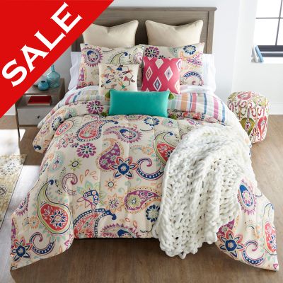 Cali Comforter Bedding Set with coordinating decor pillows in a bedroom setting. 