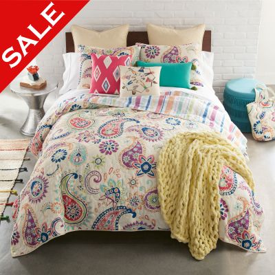 Cali quilted bedding set with coordinating decor pillows and throw in a bedroom setting. Accessories sold separately.