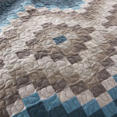This quilt features a weathered southwestern geometric pattern.