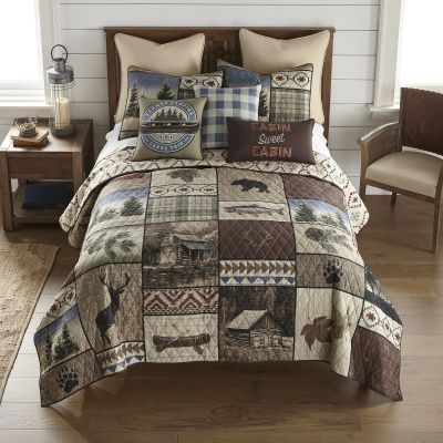 Colors on this quilt include pine green, country blue, sand, dark red, umber, and black.