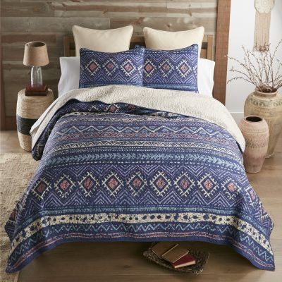 Southwestern style quilt with weathered finish in colors of navy, teal, coral and purple.