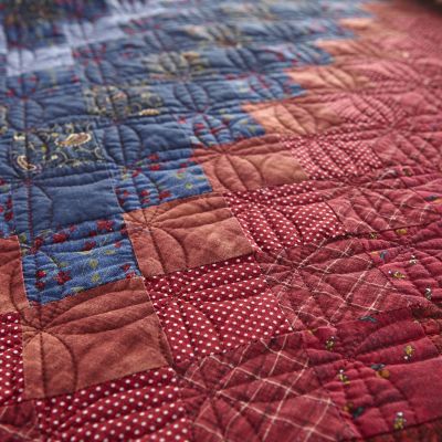 Colors in this vibrant quilt include red, blue, and yellow.