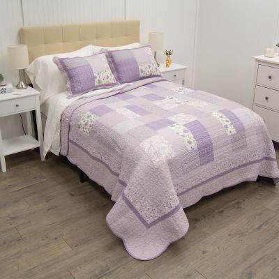 Lavender Rose on a bed in a bedroom.