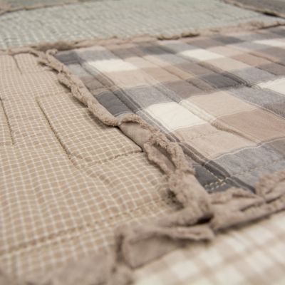 This quilt features soft woven plaids in neutral colors.