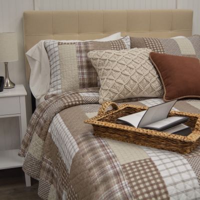 This handsome cotton bedding ensemble features classic plaid and gingham prints arranged in a hopscotch pattern.