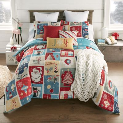 Retro Christmas Comforter from Donna Sharp displays a variety of whimsical Christmas themed motifs in blue, red, tan, and white. Set includes comforter and two shams.