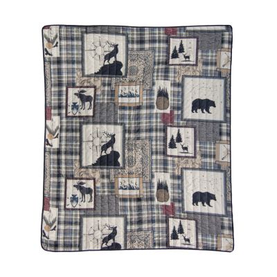 Forest Symbols throw image shows wildlife images and symbols found in nature on a plaid background.