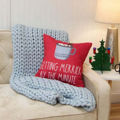 This square pillow is red and features a cup of hot cocoa and says 