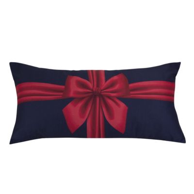 This rectangular pillow is blue and features a red ribbon tied in a bow.