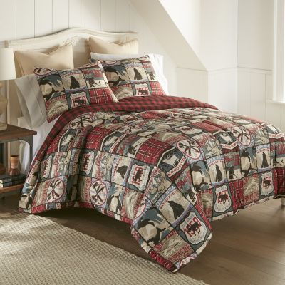 This comforter features ivory, chocolate brown, tan, red, pine green, and blue.