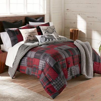 This cozy comforter features shades of grey, black, and red.