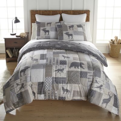 This plush comforter set is a rustic patchwork design featuring bears, moose, deer, fox, wolf and birds.