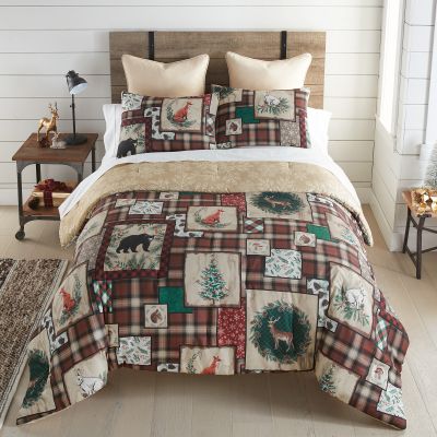 A queen comforter set from the Woodland Holiday collection, featuring rustic woodland motifs on a plaid background, perfect for creating a cozy and inviting atmosphere in your bedroom.