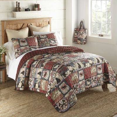 This quilt has an outdoor theme with a series of wilderness signs in a block pattern.