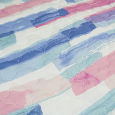This fun quilted bedding set has a brush stroke pattern in blush, peach, soft fuchsia, and aqua. 
