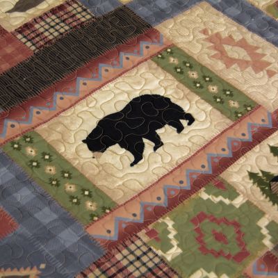 This quilt features red, chestnut, brown, green, tan, parchment, and blue.