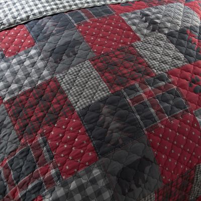 Colors in this quilt include black, red, and shades of grey.