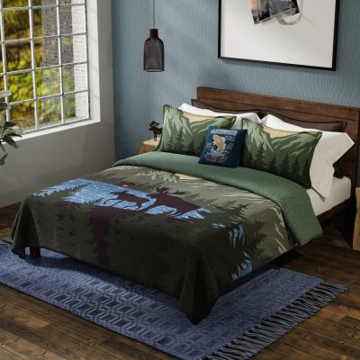 Quilt colors include dark brown, shades of green, blue, and yellow.
