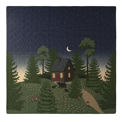quilt design featuring a little cottage on a wooded hill in colors of green, caramel, blue, red, charcoal and wheat.